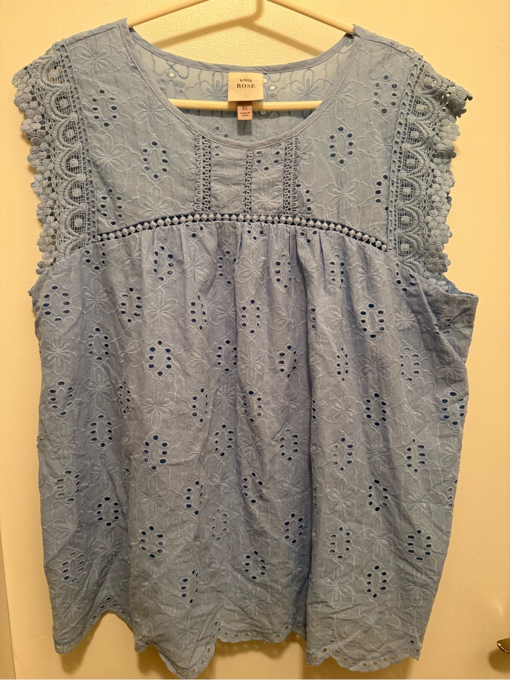 Light blue sleeveless eyelet blouse